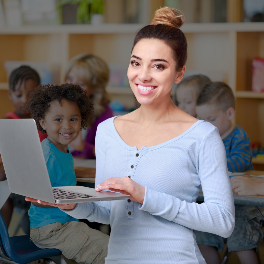Managed IT services for education organizations. Secure student data, keep systems reliable, and support staff and students with dependable IT from Arsenal Dev. Teacher holding a laptop in a classroom.